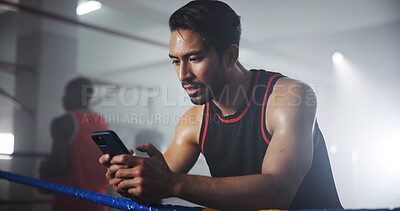 Buy stock photo Man, phone and texting at gym in boxing ring with notification, contact or tired on break at training center. Person, athlete or fighter on smartphone, mobile app or social media at martial arts club