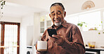 Coffee, phone and smile with old man in kitchen of retirement home for communication or text message. App, relax and social media with happy senior person drinking caffeine beverage in apartment