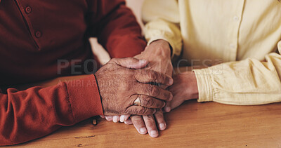 Buy stock photo Home, table and old couple with holding hands for empathy, support and comfort to partner with grief. Closeup, senior people and love with sympathy for loss, compassion and kindness with commitment