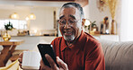 App, phone and smile of senior man on sofa in living room of home for rest or retirement. Break, happy and social media with mature person reading text message in apartment for communication