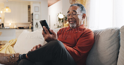 Buy stock photo Break, phone and smile of senior man on sofa in living room of home for rest or retirement. App, happy and social media with mature person reading text message in apartment for communication