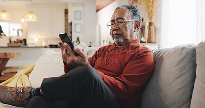 Buy stock photo Senior man, phone and reading with living room, sofa and online news blog post. Relax, digital technology and mature person with app, internet scroll and social media at home for retirement break