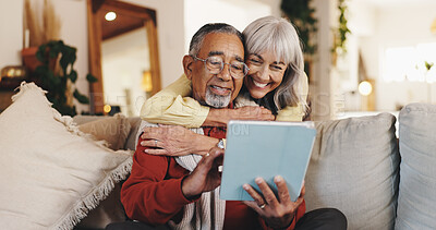 Buy stock photo Home, tablet and senior couple with hug, relax and conversation with app, love and internet. People, relationship and old man with elderly woman, tech and entertainment with social media and embrace