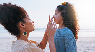 Buy stock photo Mom, girl and sunscreen for face at beach for uv protection, care and love on vacation in summer. Mother, child and application for spf lotion, skin and bonding with smile by sea on holiday in Brazil