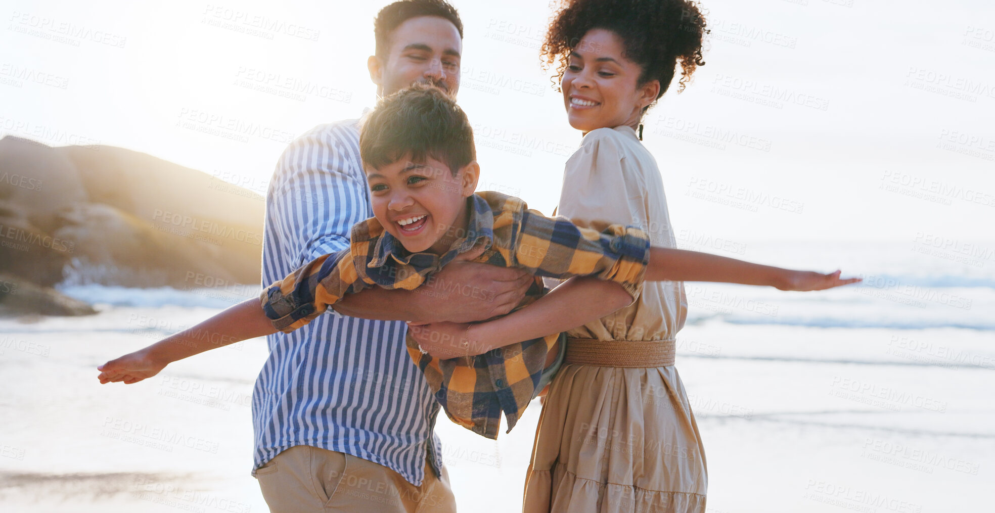 Buy stock photo Parents, boy and airplane with lift at beach, happy and playful with games, love and bonding on vacation. People, man and woman with child, flight and excited on holiday, summer and ocean in Colombia