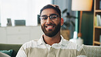 Portrait, glasses and happy man in home for relax, peace and calm on weekend break in apartment. Smile, living room and male person on sofa with comfort, resting and chill with confidence in UAE