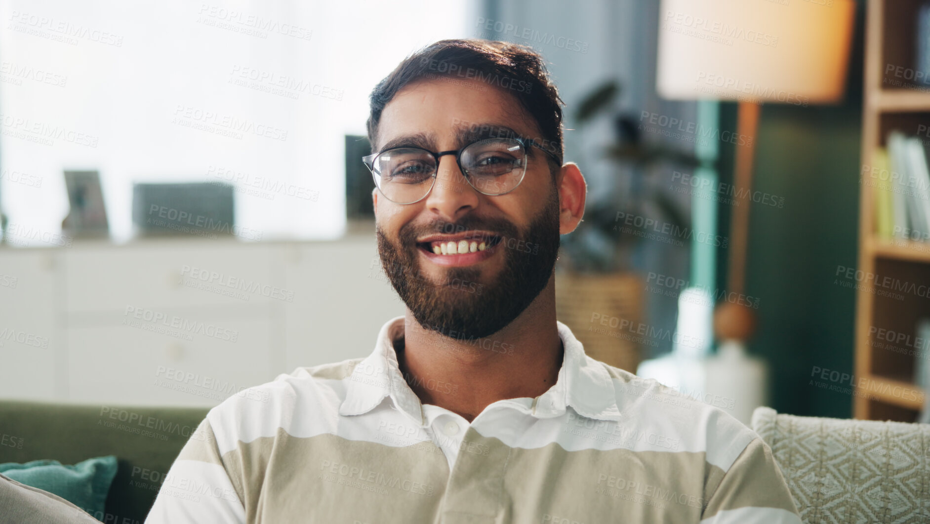 Buy stock photo Portrait, glasses and happy man in home for relax, peace and calm on weekend break in apartment. Smile, living room and male person on sofa with comfort, resting and chill with confidence in UAE