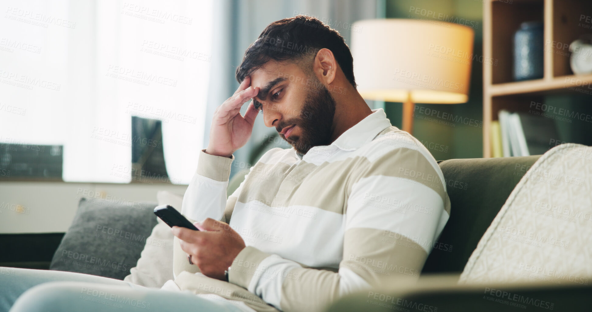 Buy stock photo Home, man and sad with reading on smartphone, online message and breakup with contact on sofa. House, male person and broken heart with technology for bad news, social media or rejected on dating app