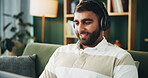 Headphones, music and man with laptop for elearning, remote education and listening to audio in home. Living room, computer and happy student with sound for college course, knowledge or study online
