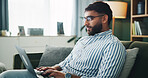 Home, man and typing on laptop for remote work, online information and story for publication. Sofa, freelancer and male content writer with tech for research, copywriting and article website in house