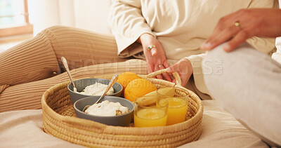 Buy stock photo Home, couple and hands in bed for breakfast, nutrition and bonding together on weekend holiday. Closeup, morning and people with food for wellness, healthy diet or porridge with orange juice in house