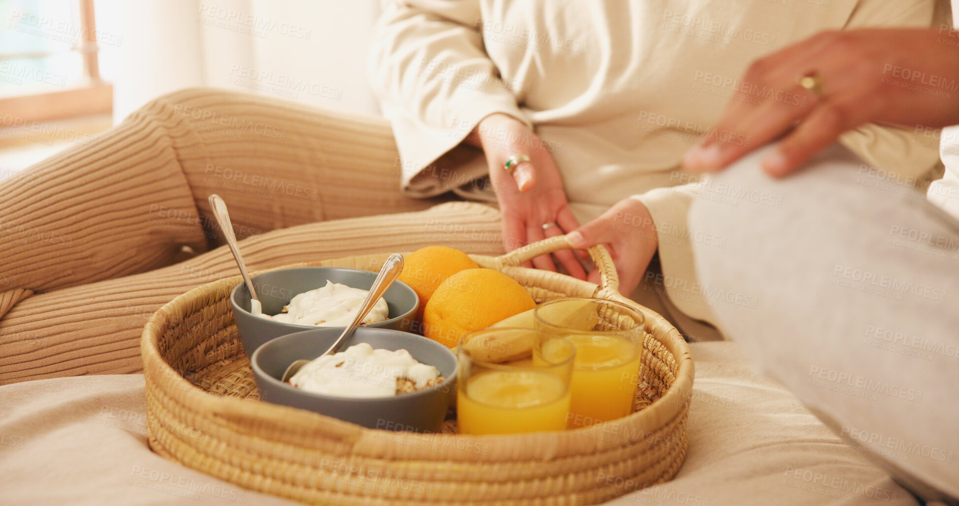 Buy stock photo Home, couple and hands in bed for breakfast, nutrition and bonding together on weekend holiday. Closeup, morning and people with food for wellness, healthy diet or porridge with orange juice in house