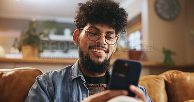 Buy stock photo Man, happy and relax with phone on sofa for social media scroll, mobile chat or reading online news. Smile, person or smartphone in home for streaming subscription, app download or browse dating site