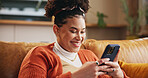 Girl, happy and typing with phone on sofa for dating site chat, reading online news and social media post. Gen z person, relax or smile with smartphone in home for streaming service and communication