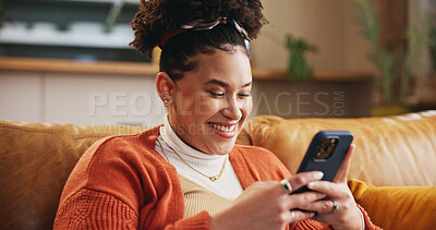 Buy stock photo Girl, happy and typing with phone on sofa for dating site chat, reading online news and social media post. Gen z person, relax or smile with smartphone in home for streaming service and communication