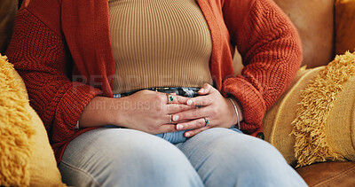 Buy stock photo Hands, pain and person with stomach cramps, constipation and sick with irritable bowel syndrome on sofa. House, illness and woman with pelvic inflammatory disease, menstruation and touch of belly