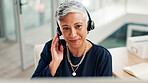 Mature, happy woman or agent talking with headset at call center for online communication. Female person, consultant or employee with mic or technology for virtual assistance or customer service