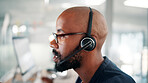 Office, call center and man with headset on computer for contact us, crm service and customer support. Business, professional consultant and person talking for communication, advice and feedback