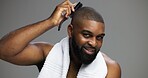 Black man, portrait and brush hair in studio for grooming, morning routine and self care maintenance. Haircare, mockup and person with cosmetics tool on gray background for clean style and confidence