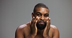 Cream, skincare and portrait of black man in studio for beauty, grooming and dermatology. Cosmetics, glow and self care with person and lotion on gray background for hydration, hygiene and shine