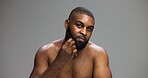 Man, portrait and comb beard in studio for grooming routine, detangle facial hair and self care maintenance. Mockup space, black person and cosmetics tool on gray background for styling and hygiene