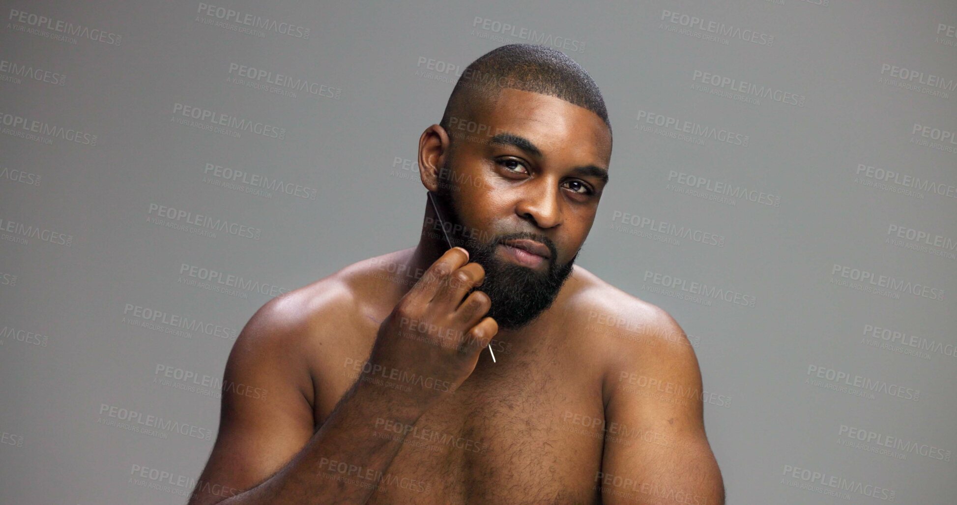 Buy stock photo Man, portrait and comb beard in studio for grooming routine, detangle facial hair and self care maintenance. Mockup space, black person and cosmetics tool on gray background for styling and hygiene
