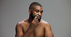 Black man, portrait or skincare in studio with roller or product for facial massage on grey background. Cheek, crystal stone treatment or model with dermatology cosmetic beauty glow or mockup space