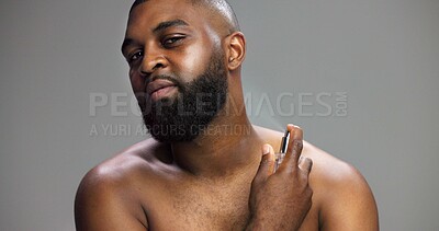 Buy stock photo Hygiene, black man and portrait with perfume in studio for grooming routine, fresh fragrance and odor prevention. Mockup space, person and spray cologne on gray background for self care or body scent