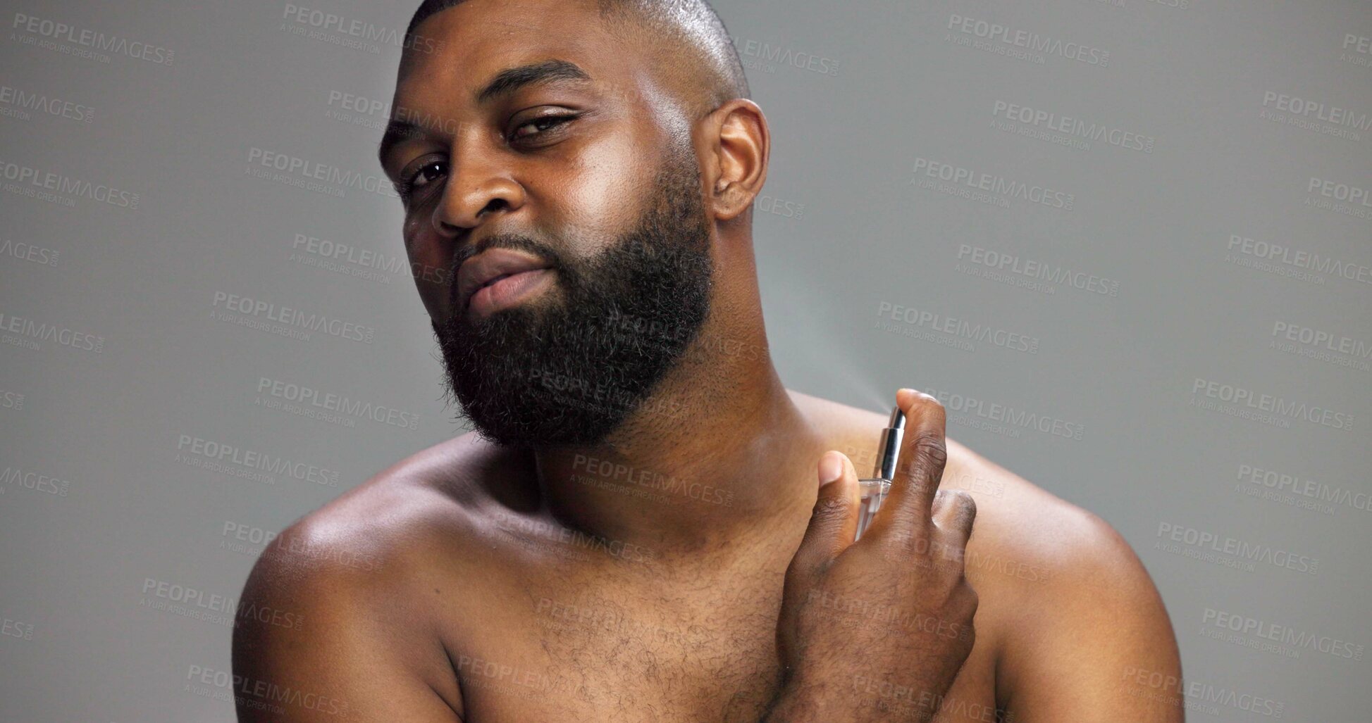 Buy stock photo Hygiene, black man and portrait with perfume in studio for grooming routine, fresh fragrance and odor prevention. Mockup space, person and spray cologne on gray background for self care or body scent