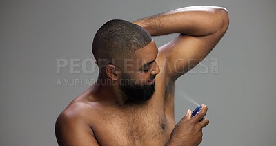 Buy stock photo Grooming, studio and man with spray, armpit and self care with product for smell, smile or fragrance. Gray background, happy and black person with cosmetics for hygiene, routine or scent for underarm