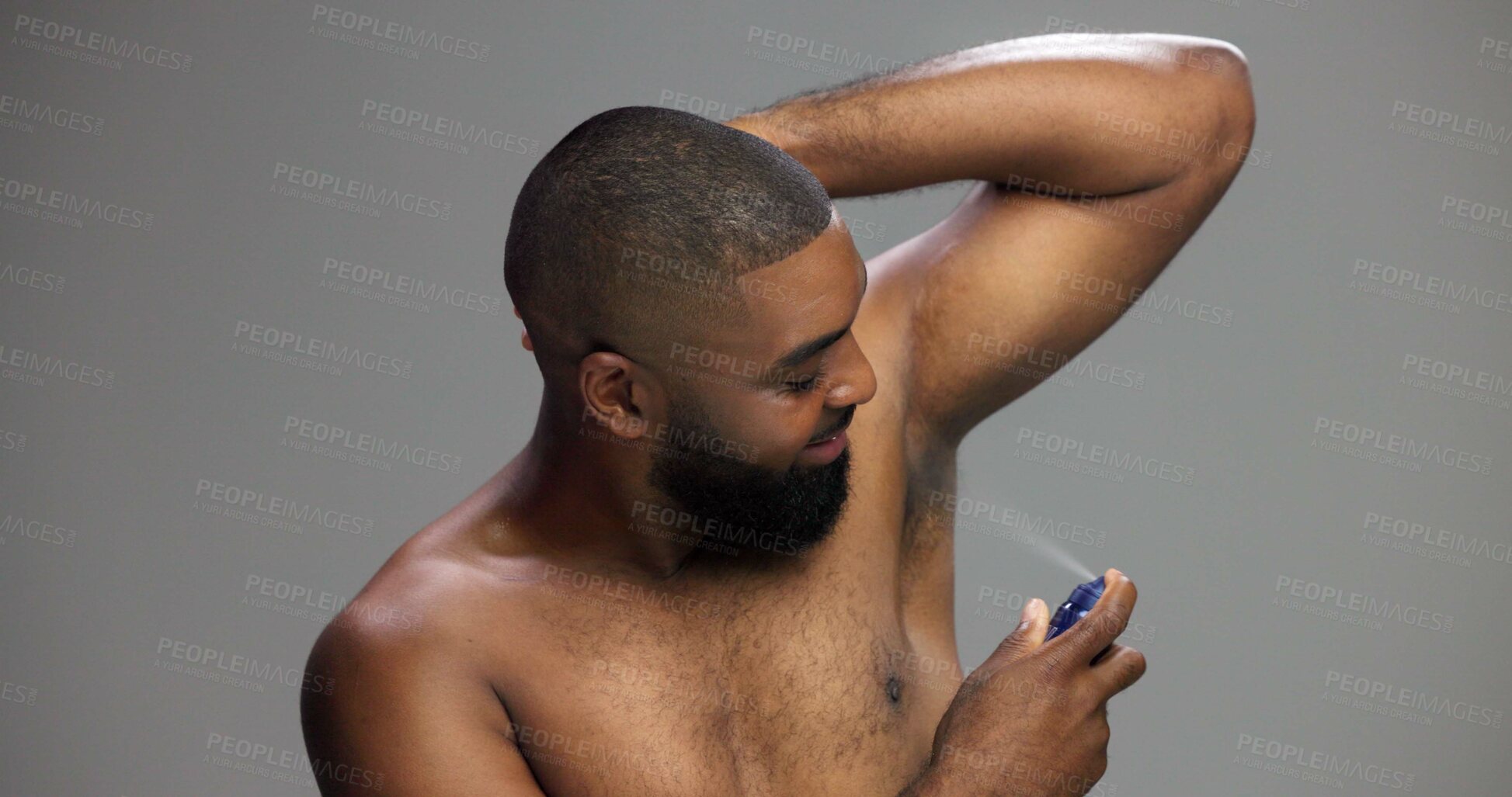 Buy stock photo Grooming, studio and man with spray, armpit and self care with product for smell, smile or fragrance. Gray background, happy and black person with cosmetics for hygiene, routine or scent for underarm