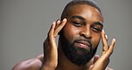 Facial, skincare and portrait of black man in studio for salon, grooming and dermatology. Cosmetics, glow and self care with person and beauty on gray background for hydration, hygiene and shine