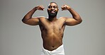 Smile, power and black man flexing in studio portrait with health, wellness and confidence in morning grooming. Bathroom space, muscle fitness and strong arms of happy person on grey background.