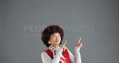 Buy stock photo Woman, pointing and information in studio for advertising, announcement or news about us on gray background. Mockup space, presentation or coming soon with hand gesture, sign or direction for launch