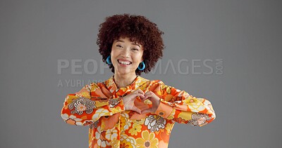 Buy stock photo Happy woman, portrait and fashion with heart hands in studio for retro style on a gray background. Face, female person or model with smile, afro or romantic gesture for love in vintage clothing