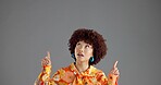Woman, pointing up in studio and fashion announcement, notice or information with retro style promo. Ads, mockup or space for news, afro person or vintage clothes coming soon on gray background