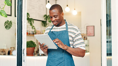 Buy stock photo Barista, tablet and reading with black man in cafe for research, digital inventory or restaurant supply checklist. Waiter, catering review and small business owner with person in coffee shop for menu