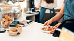Hands, serving and waiter with breakfast in cafe for order, help or customer service at counter. Food, nutrition and closeup of barista with chocolate croissant for morning meal in coffee shop