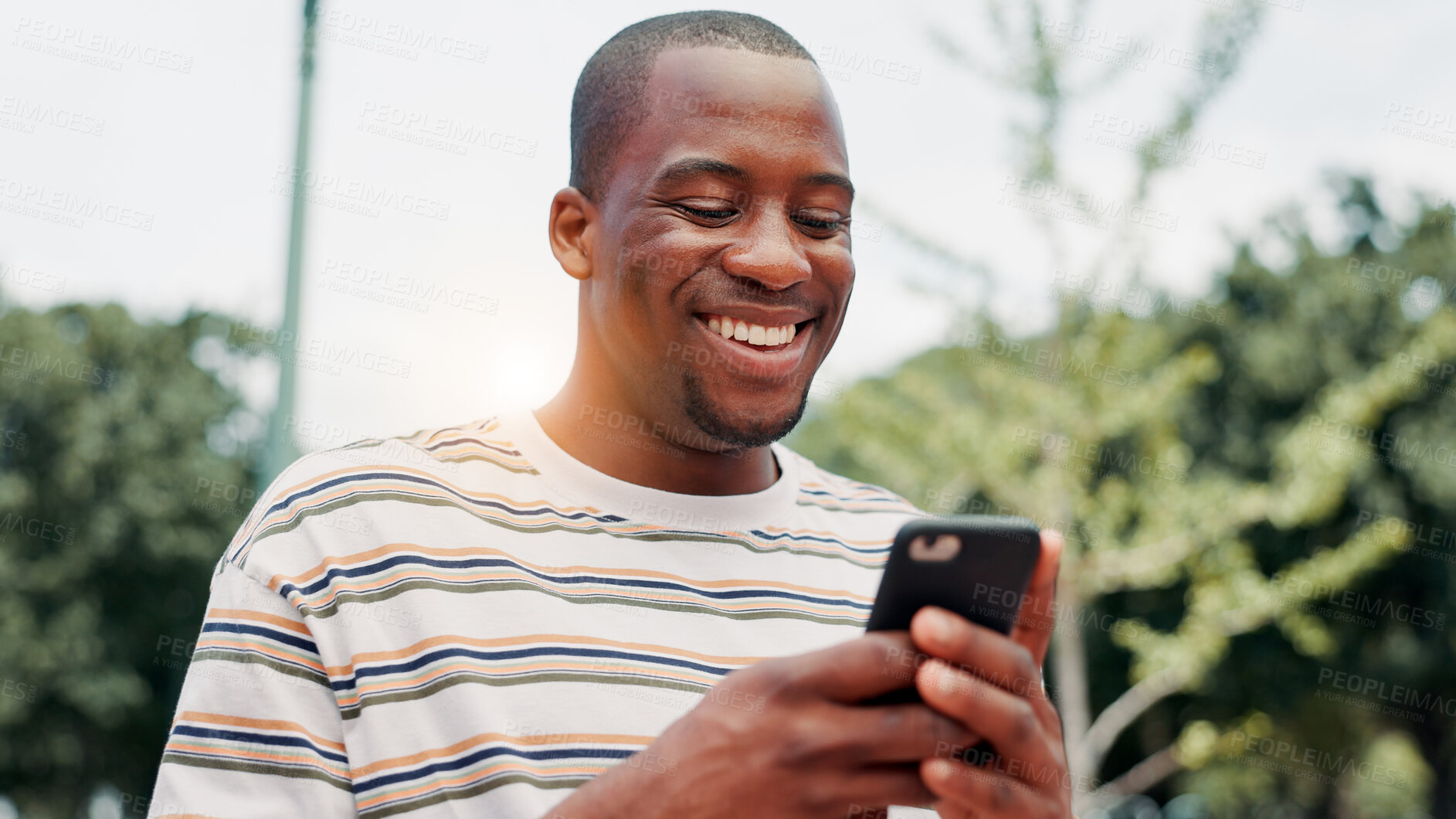 Buy stock photo Park, black man and hands with smartphone for social media, online communication and comment for reel. Outdoor, male person and laughing with mobile for application, funny joke and chat with contact