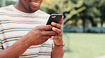 Outdoor, hands and man with smartphone, texting and happy for message on app, communication and online. Park, digital and person with mobile for chat, smile and typing with tech on social media