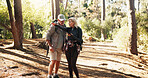 Directions, hiking and phone with old couple in forest together to search for route to destination. App, lost and pointing with senior people outdoor in nature for health, exercise or fitness