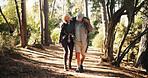 Mature, couple and hiking with help for injury, fatigue or accident with support for walking. Travel, adventure and man assisting woman for trekking mistake, care or aid with sprain outdoor in forest