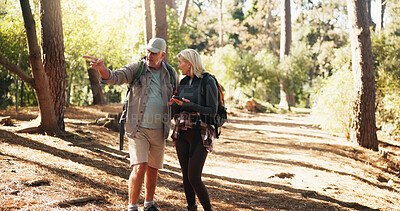 Buy stock photo Destination, phone and pointing with old couple in forest together to search for directions. App, lost and map with senior people outdoor in nature or woods for exercise, fitness and navigation