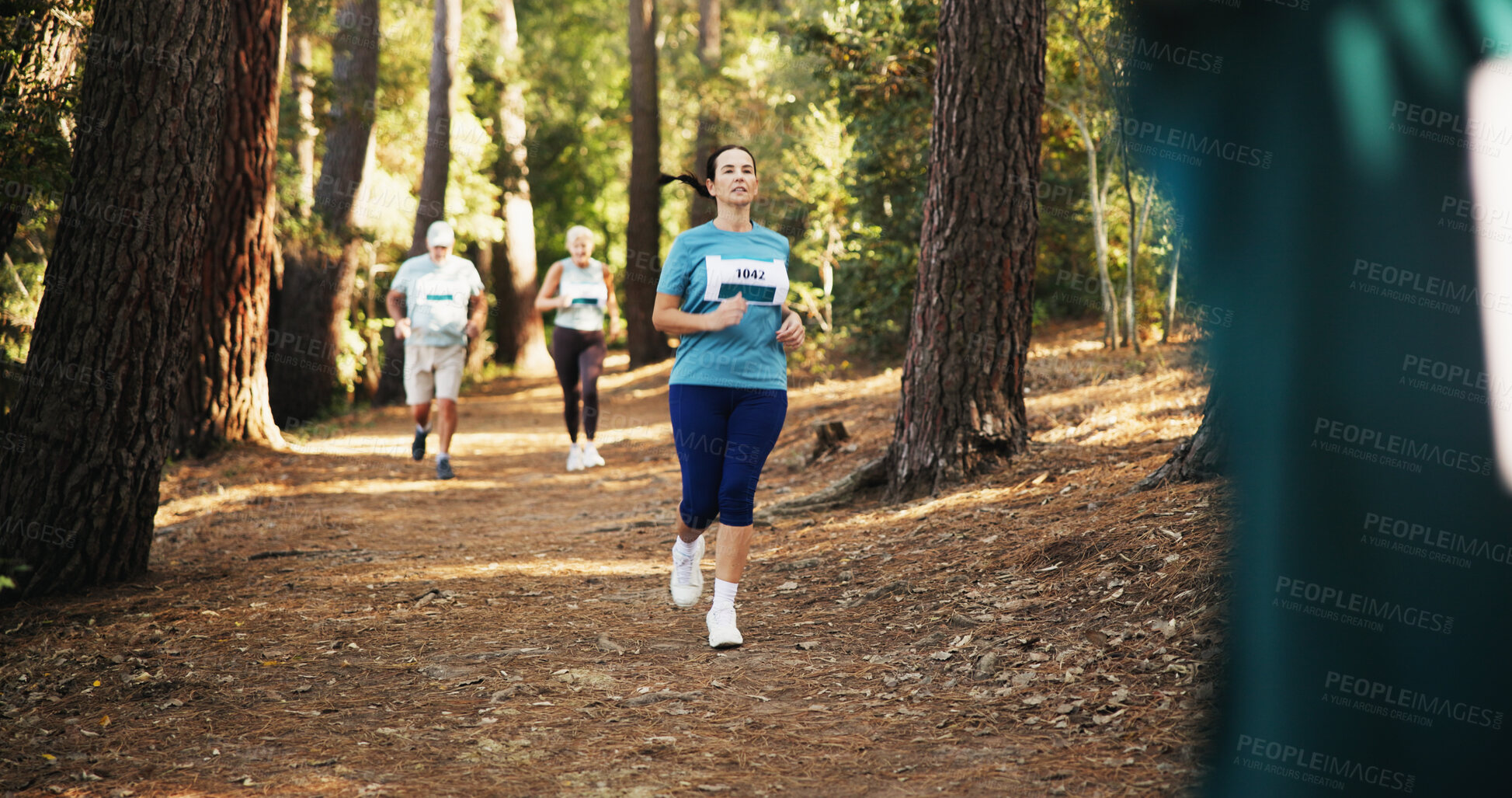 Buy stock photo Action, fitness and marathon with woman in forest for challenge, performance or race. Cardio, competition and running with mature athlete at rally event in nature or woods for course, heat or trial