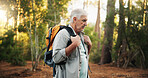 Woods, backpacking and senior man hiking with travel, adventure or journey on vacation. Outdoor, fitness and elderly male person trekking in forest for discovery on holiday or weekend trip in nature.