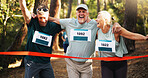 Win, people running and help to finish line for exercise aid, fitness or champion in forest. Mature team, excited runner and celebration for race with success, goal and sports achievement at marathon