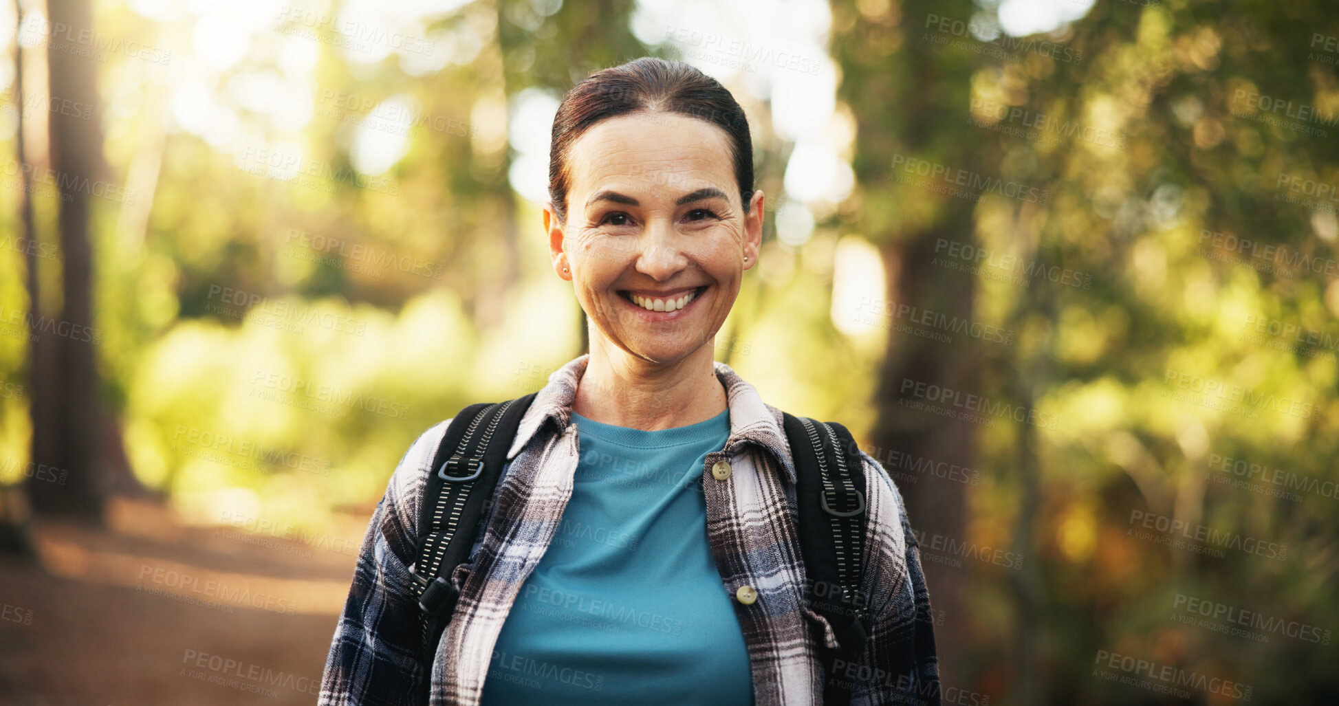 Buy stock photo Portrait, mature and happy woman trekking in forest for travel, holiday and vacation on adventure. Smile, hiking and female person in woods for backpacking, tourism and explore nature in Switzerland