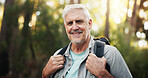 Portrait, backpacking and senior man in forest, journey and adventure in nature, outdoor and retirement. Hiking, travel and elderly person on holiday in woods, trekking and exploration of environment
