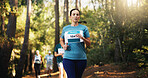 Competition, fitness and marathon with woman in forest for challenge, performance or race. Action, cardio and running with mature athlete at rally event in nature or woods for course, heat or trial