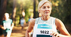 Competition, marathon and running with woman in forest for challenge, performance or race. Action, cardio and fitness with mature runner at rally event in nature or woods for course, heat or trial